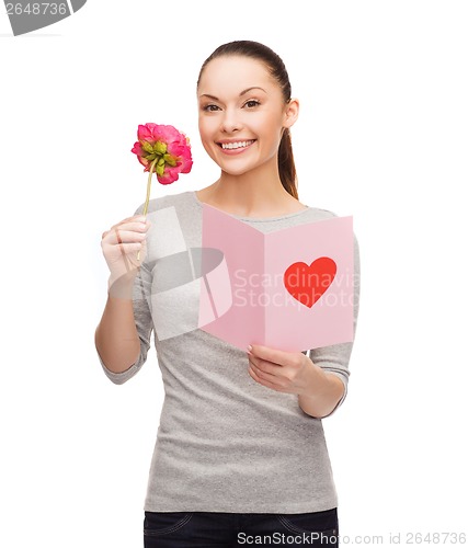 Image of smiling woman with postcard and flower