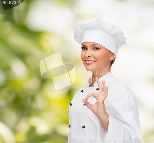 Image of smiling female chef showing ok hand sign