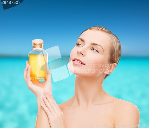 Image of lovely woman with oil bottle