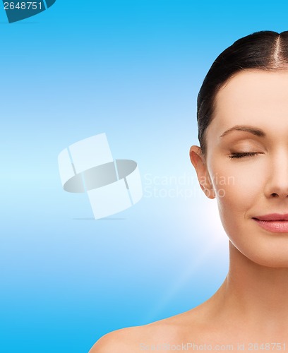 Image of young calm woman with closed eyes