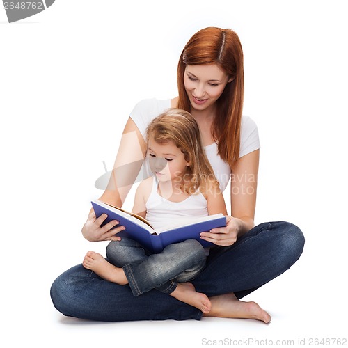 Image of happy mother with adorable little girl and book