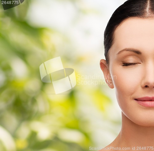 Image of young calm woman with closed eyes
