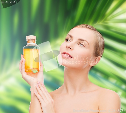 Image of lovely woman with oil bottle