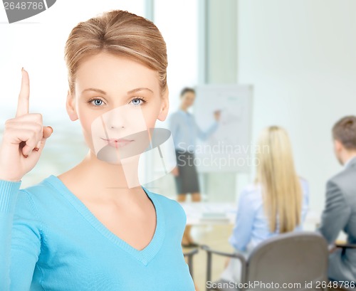 Image of woman with finger up at office