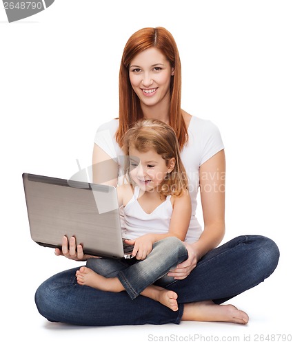 Image of happy mother with adorable little girl and laptop