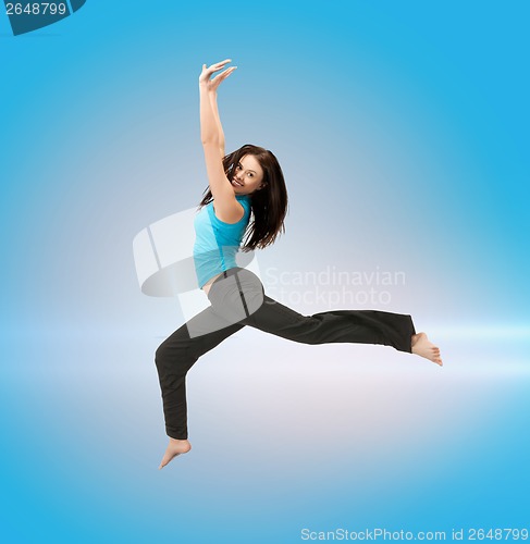 Image of sporty woman jumping in sportswear