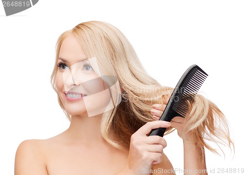 Image of smiling woman with hair brush