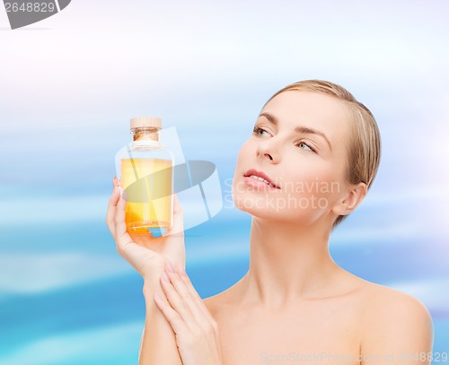 Image of lovely woman with oil bottle