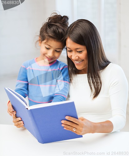 Image of mother and daughter with book