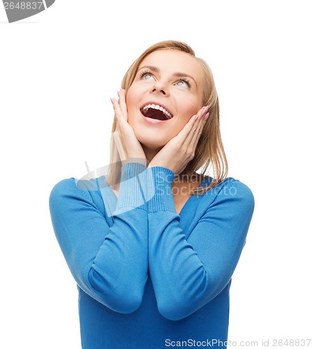 Image of amazed laughing young woman