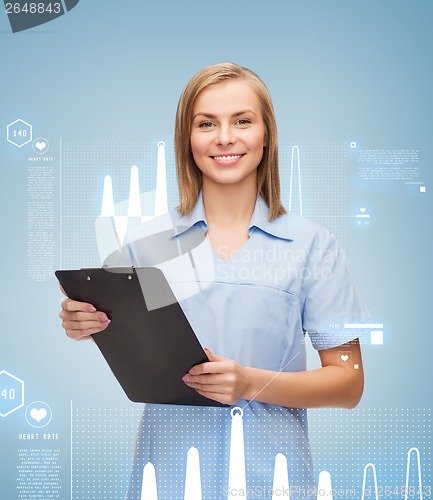 Image of smiling female doctor or nurse with clipboard