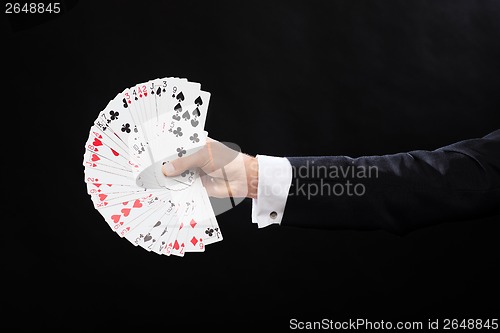 Image of close up of magician hand holding playing cards