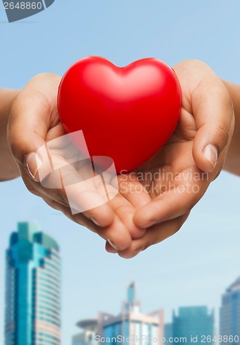 Image of womans cupped hands showing red heart