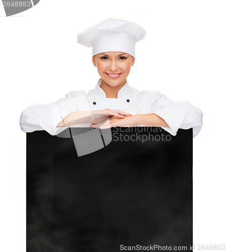 Image of smiling female chef with white blank board