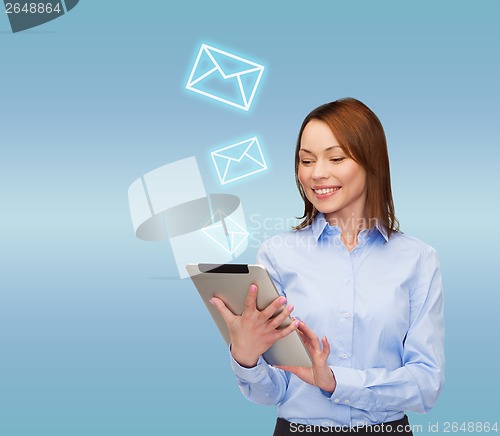 Image of smiling woman looking at tablet pc