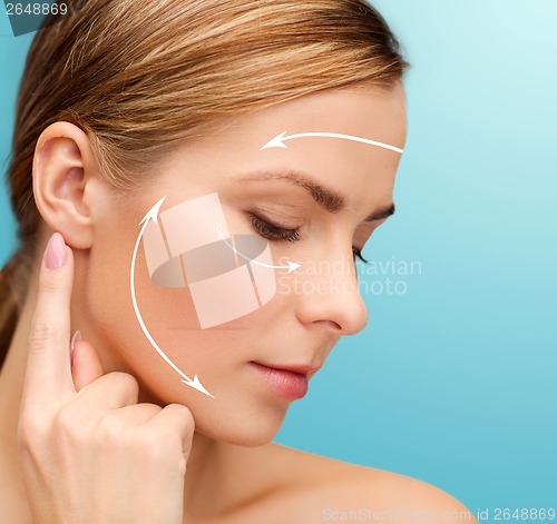 Image of calm woman touching her ear