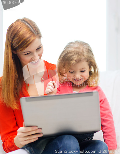 Image of happy mother and daughter with laptop computer