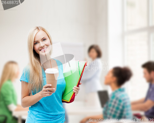 Image of smiling student with folders