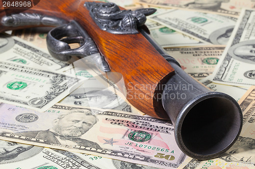 Image of Old gun and money