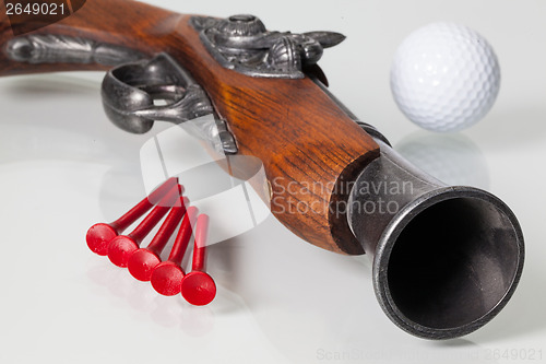 Image of Old gun and golf equipments