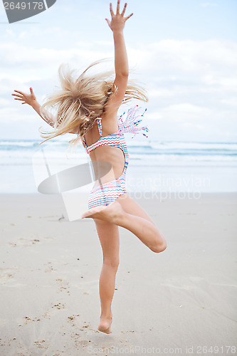 Image of Young girl having fun at beach