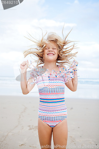 Image of Young girl having fun at beach