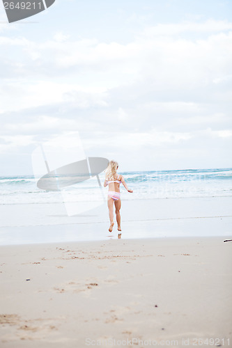 Image of Young girl running at beach