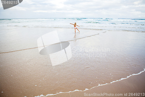 Image of Young girl having fun at beach