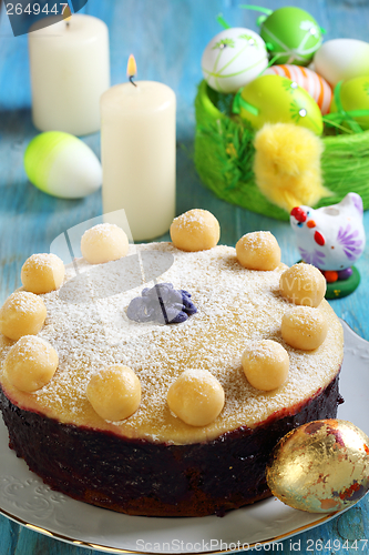 Image of Easter cake and basket with colorful eggs.