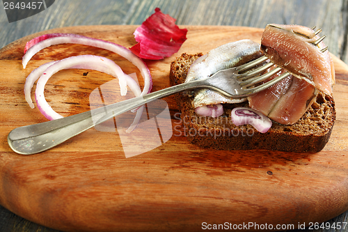 Image of Fork with anchovies closeup.