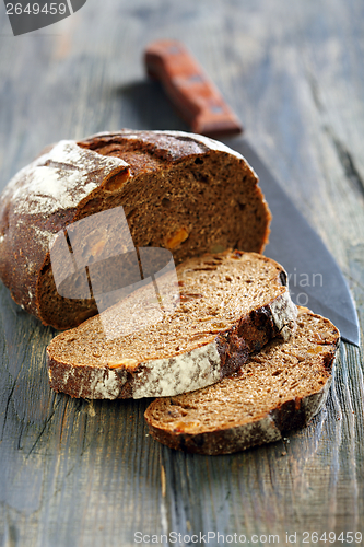 Image of Rye bread with dried apricots and a knife.