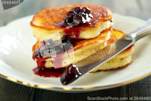 Image of Pancakes with ricotta and cowberry sauce. 