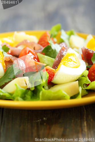 Image of Salad and potatoes, egg and anchovies.