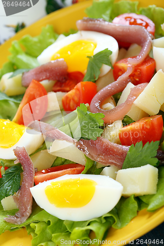 Image of Salad with eggs, cherry tomatoes and anchovies.