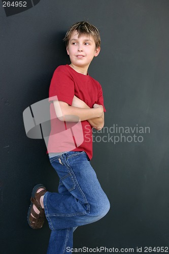 Image of Boy leaning against wall