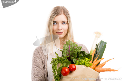 Image of Beautiful woman carrying vegetables