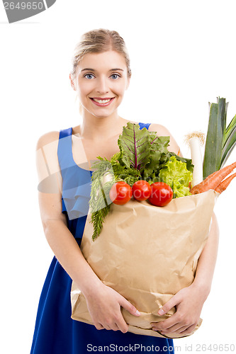 Image of Beautiful woman carrying vegetables