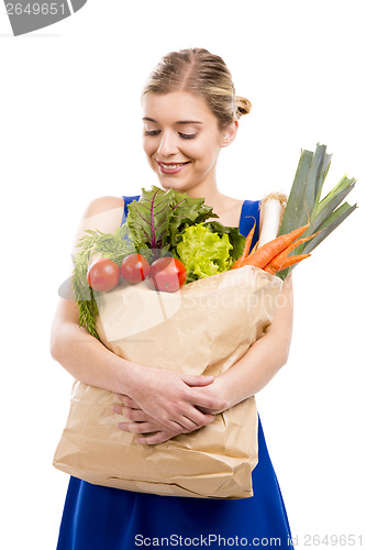 Image of Beautiful woman carrying vegetables