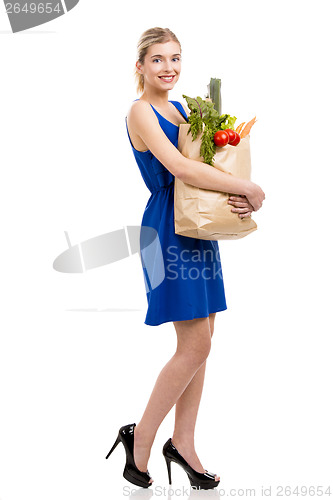 Image of Beautiful woman carrying vegetables