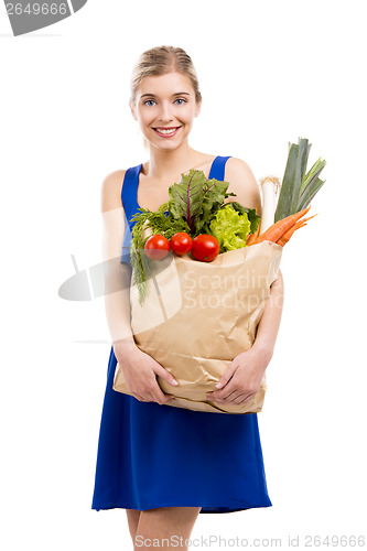 Image of Beautiful woman carrying vegetables