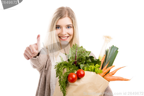 Image of Beautiful woman carrying vegetables