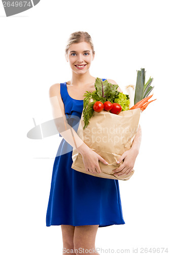 Image of Beautiful woman carrying vegetables