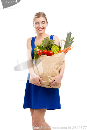 Image of Beautiful woman carrying vegetables