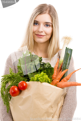 Image of Beautiful woman carrying vegetables