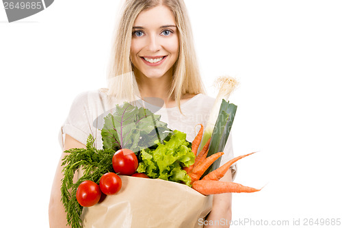 Image of Beautiful woman carrying vegetables