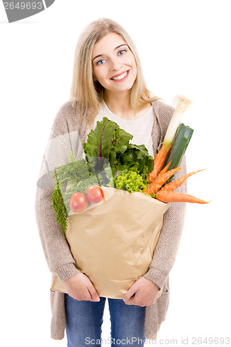 Image of Beautiful woman carrying vegetables