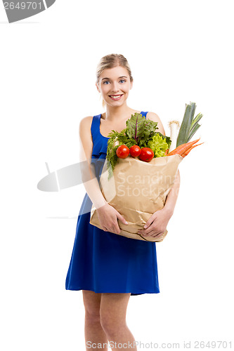 Image of Beautiful woman carrying vegetables