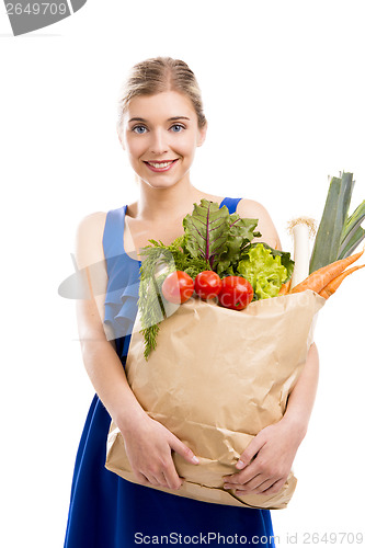 Image of Beautiful woman carrying vegetables