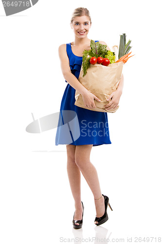 Image of Beautiful woman carrying vegetables