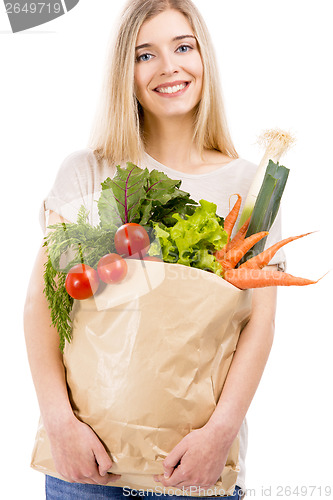 Image of Beautiful woman carrying vegetables